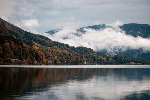 Lake Mondsee with autumn forest and low clouds