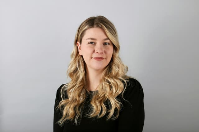 Headshot of a woman against a light grey background