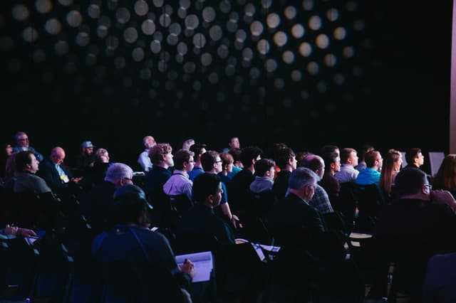 Audience at a conference in front of a stage
