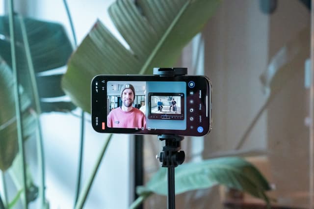 Smartphone on a tripod recording a person
